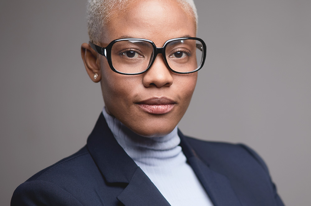 Picture of a woman wearing glasses for the product line of Constitution lenses from FEA Industries.