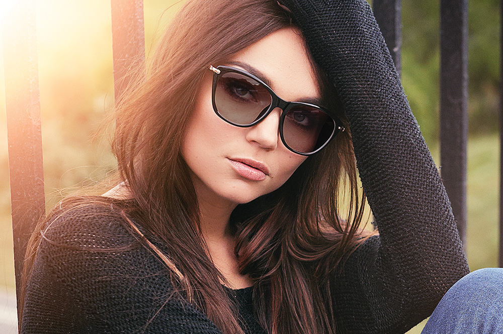 Picture of a woman wearing glasses for the product line of Photochromic lenses from FEA Industries.