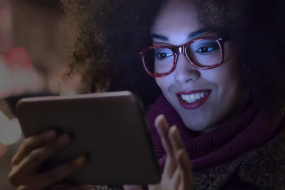 Picture of a woman wearing glasses for the product line of Shamir lenses from FEA Industries.