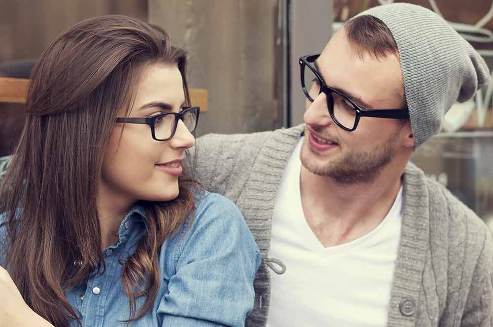 Picture of a man and woman wearing glasses for the product line of Signet Armorlite lenses from FEA Industries.